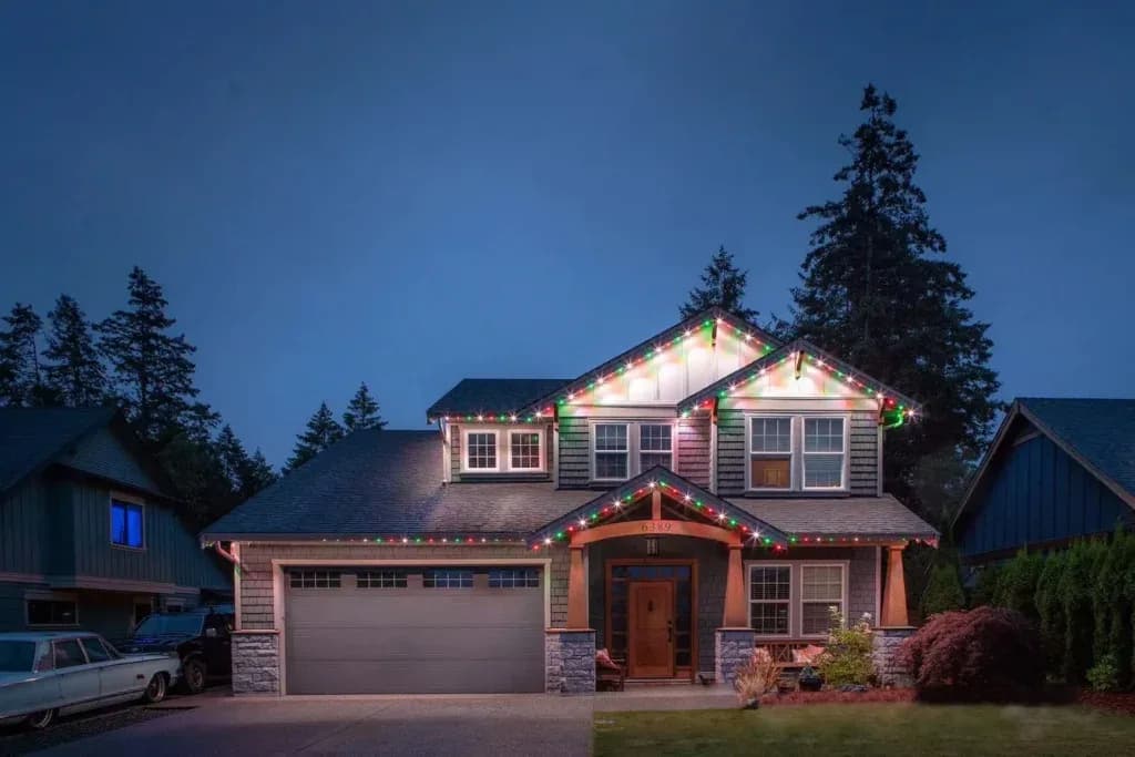 Installer fastening aluminum LED track into a soffit with white screws