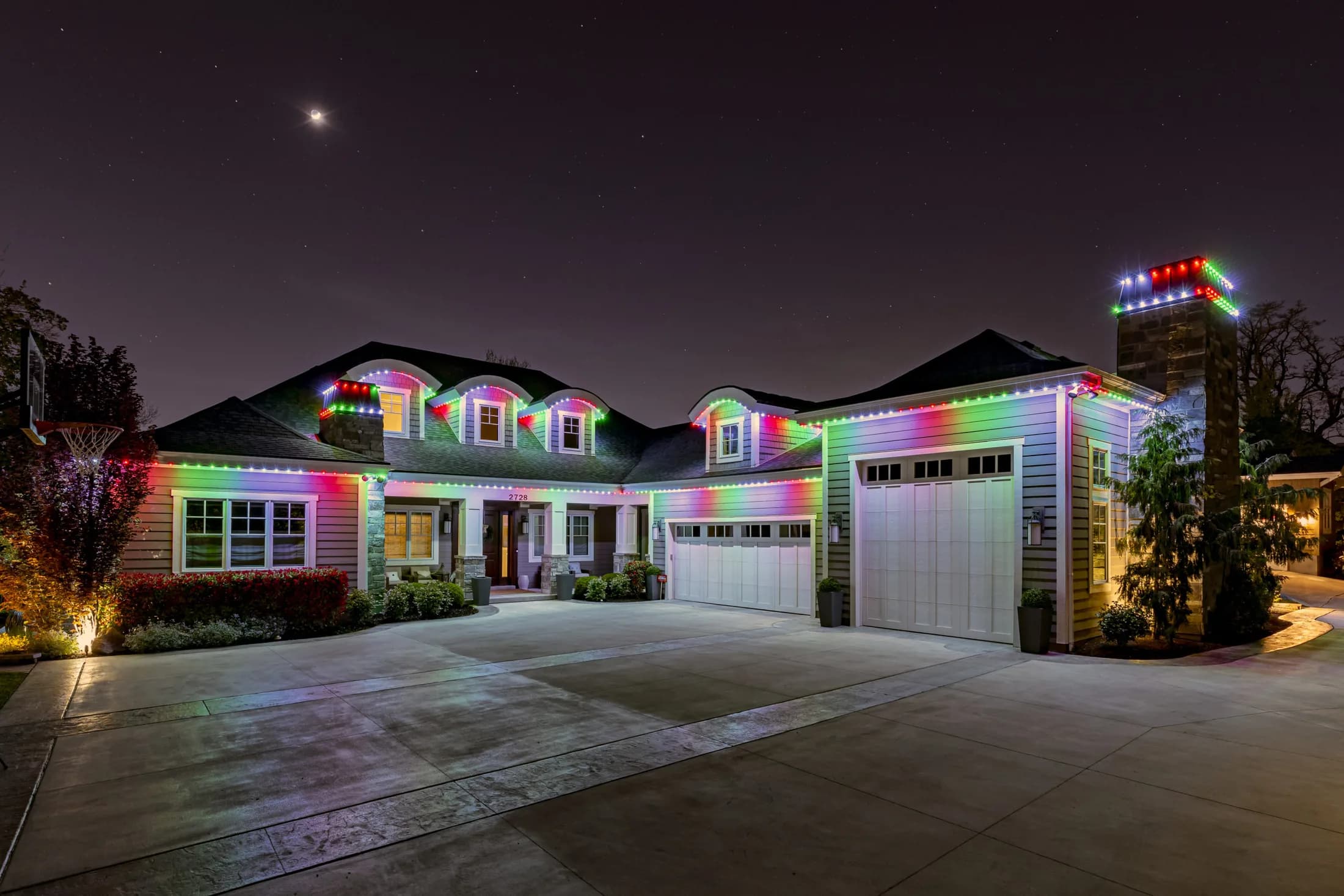 Modern home with warm permanent LED accent lighting along the roof and garage