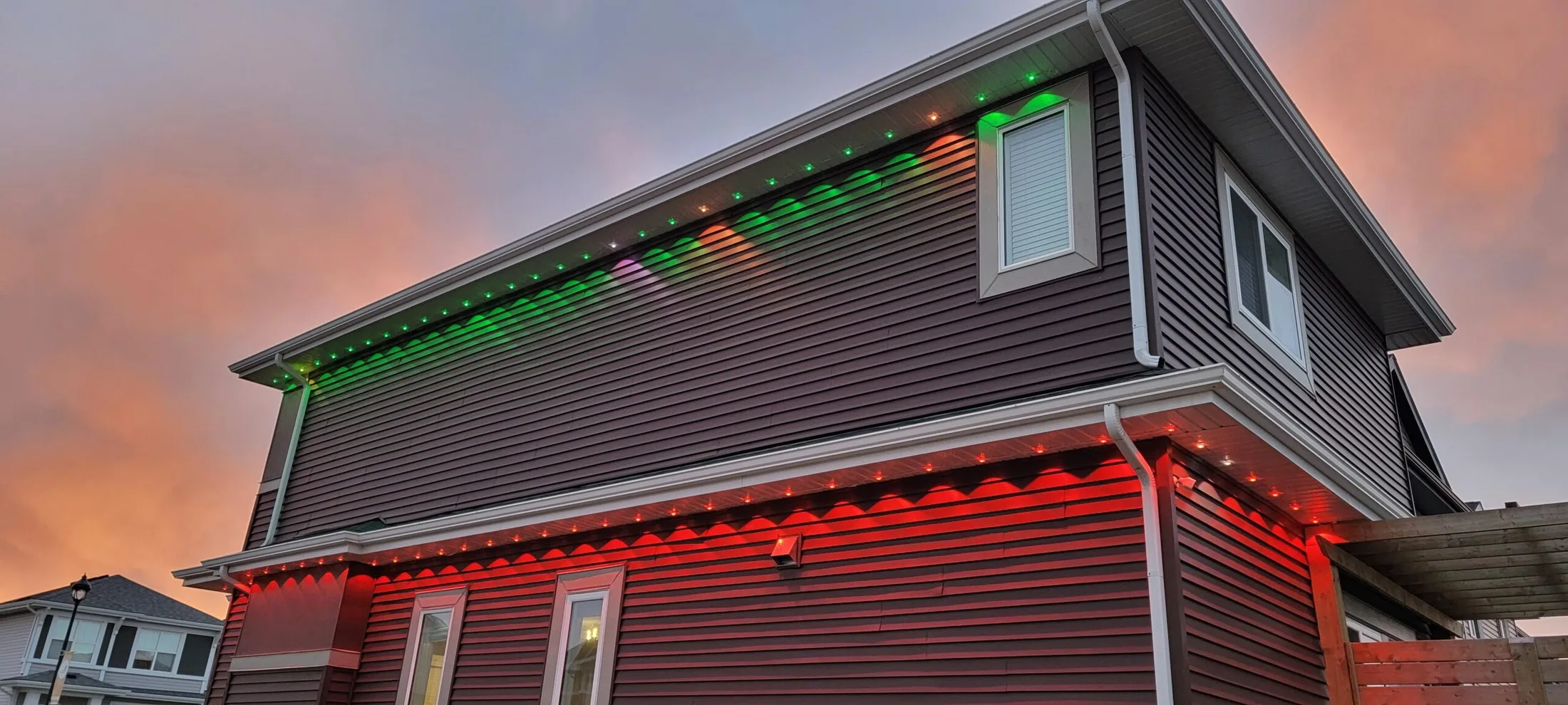 Long building elevation lit end to end with permanent LED track lighting