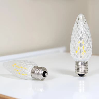 Two warm white faceted C9 LED bulbs showing the E17 screw base